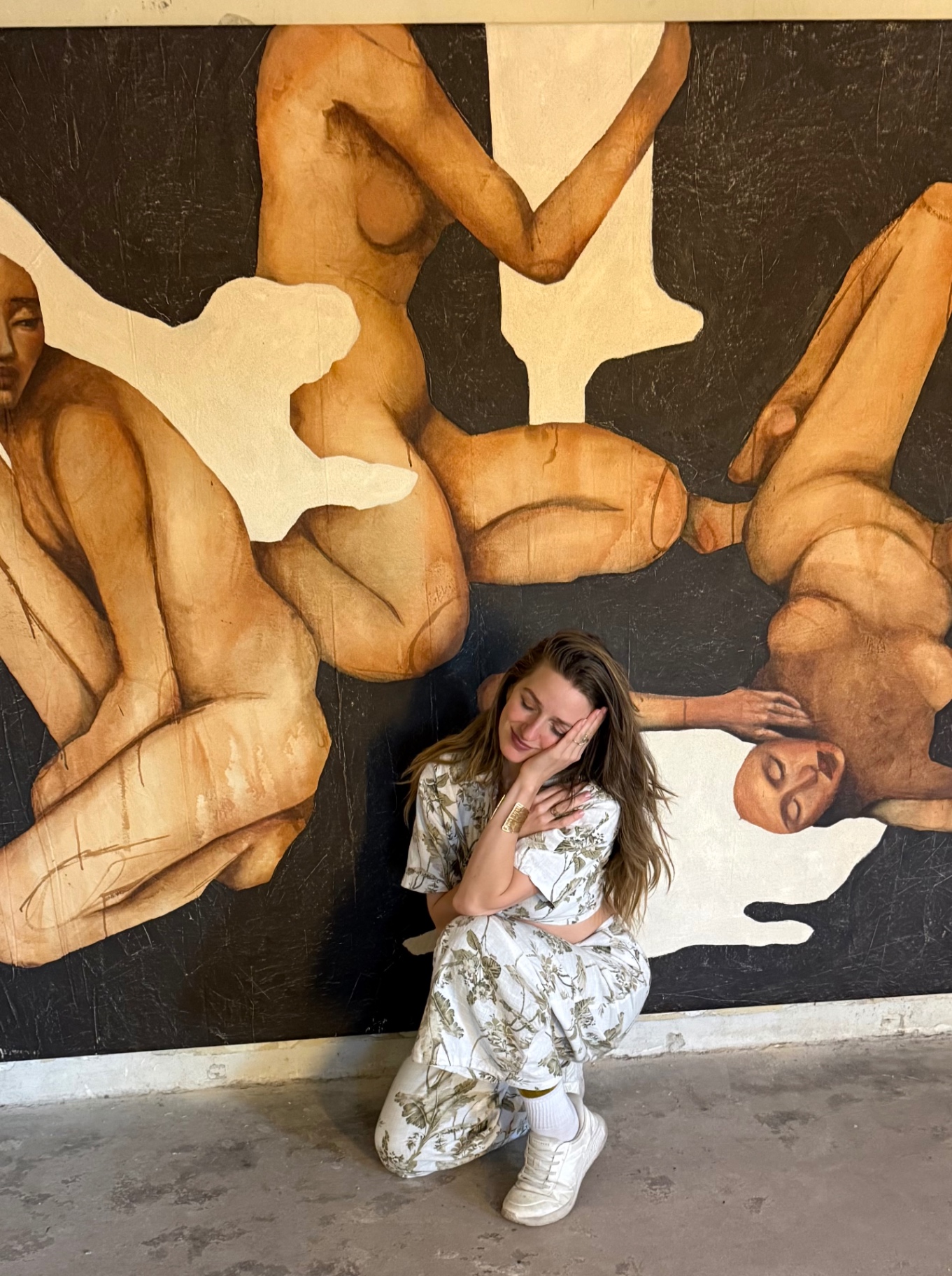 Frauke resting in front of a large figurative painting